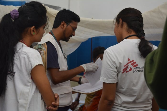 In one of their regular rounds of the In Patients Wards, MSF doctors Manoj Sarma (centre) and Sahithi (right) discuss a case of cellulitis of the foot. Photo: Parvati Tampi