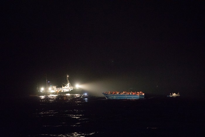 A wooden boat with 412 people on board, mainly from Asian countries such as Pakistan, Bangladesh and Nepal, is rescued at night by the MSF search and rescue ship, Vos Prudence and other vessels, in the Mediterranean Sea.
