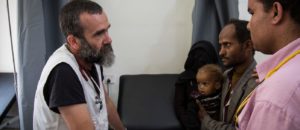 Dr Roberto Scaini, medical activity manager at Haydan hospital, explains young parents that their son has pneumonia and is showing signs of moderate malnutrition. Photo: Florian SERIEX/MSF