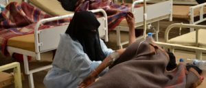 MSF nurse with a women while checking her blood pressure. Photo: Nuha Haider/MSF