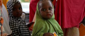 A small girl holds her MSF vaccination card in Damaturu town, in the north-eastern Nigerian state of Yobe. Photo: Igor Barbero/MSF