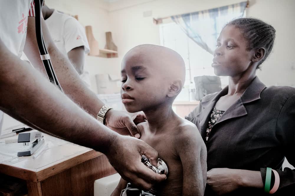 A nurse examines Gloria Chipasula, an 11-year-old living with HIV, in Chiradzulu, Malawi.