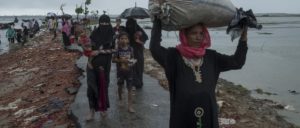 People in the rain at a border crossing on the Naf river, near Teknaf, September 19. Photo: Antonio Faccilongo