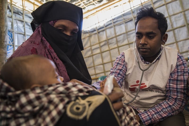 A young boy is examined by a doctor in MSF's clinic next to Nayapara refugee camp. Photo: Anna Surinyach