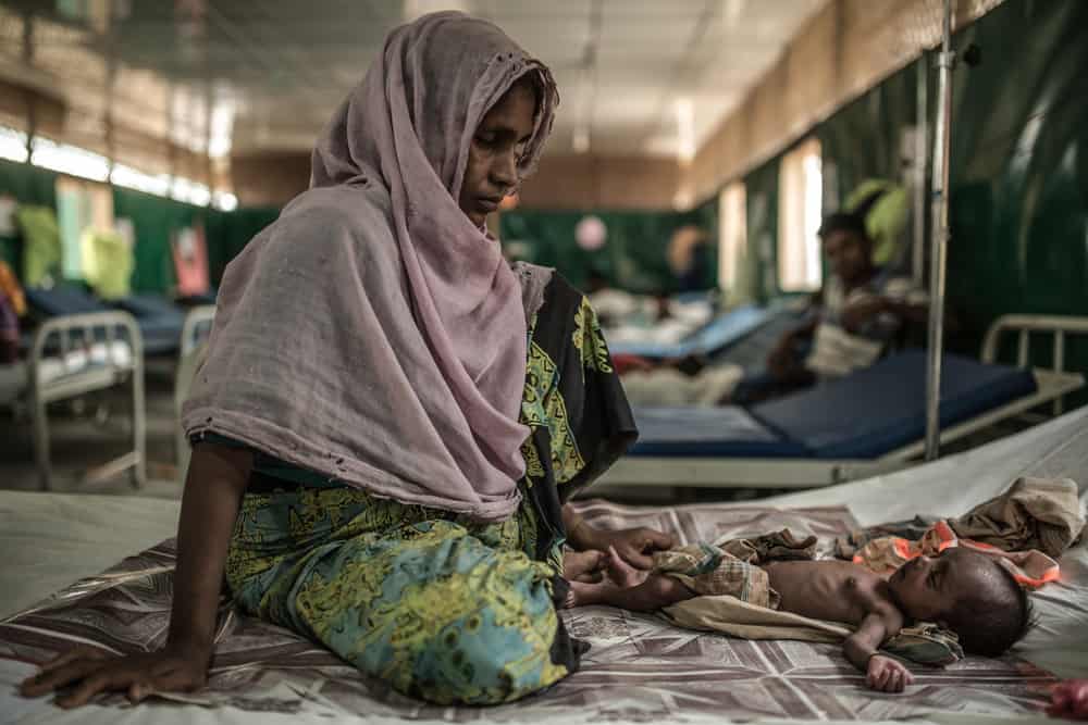 Rozia and her two-month-old son Zubair in the MSF hospital in Goyalmara. Many of the children admitted to the hospital have contracted infections from unhygienic birthing practises, and the unsanitary living conditions in the camp during their first days of life.