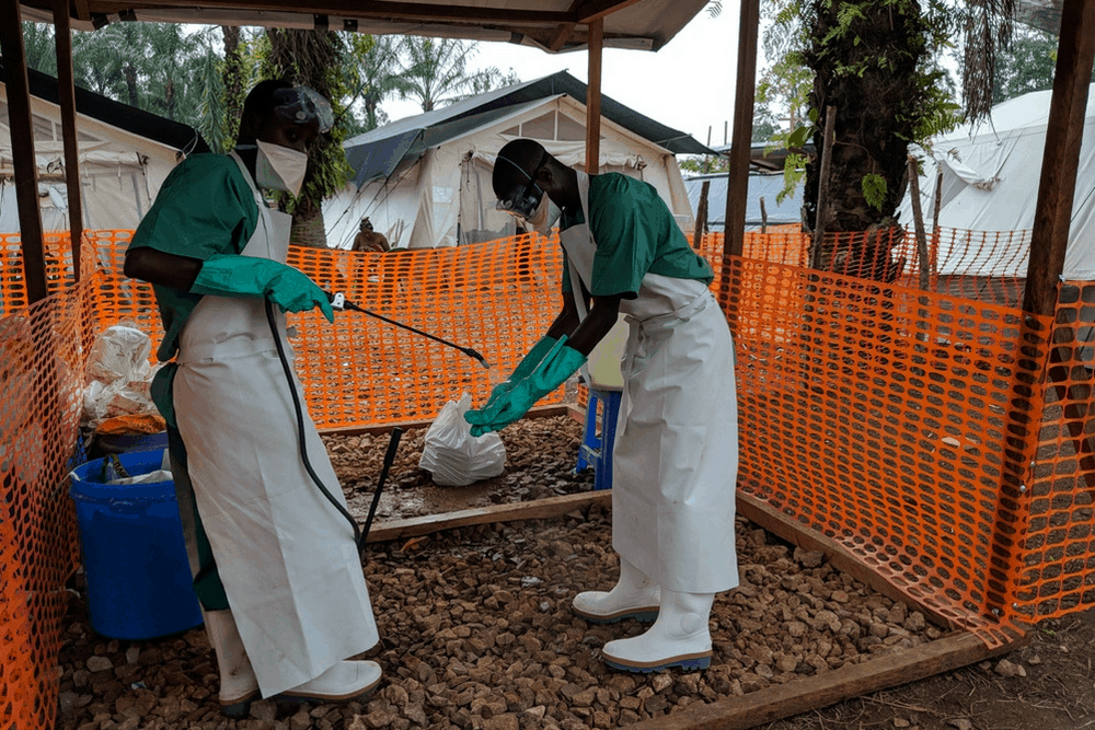 Health workers washing hands after distributing food to patients in the Ebola treatment centre in Mangina, Democratic Republic of Congo (DRC).