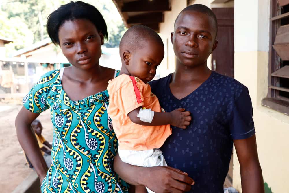 Méda and Mathuri are pictured with their son Therence outside the pediatric department of Bossangoa’s hospital. 