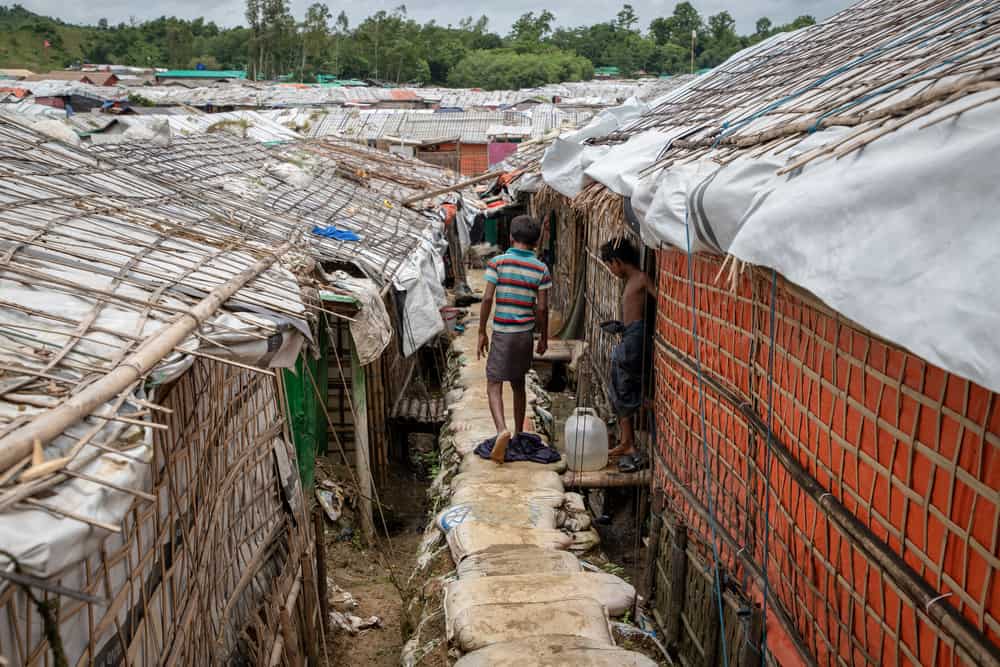 A child walks on an elevated foot path reinforced by sandbags in the Unchiprang camp in Cox’s Bazar, Bangladesh. Photo: Daphne Tolis/MSF