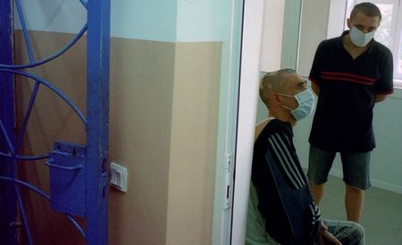 Two TB patients waiting to take their medication inside the Colony 3, a regional prison hospital for inmates with TB © Alexander Glyadyelov/MSF