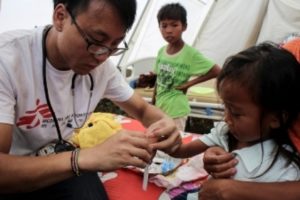 Nurse from Hong Kong, examines a patient during consultations at the Rural Health Unit in Guiuan, Eastern Samar. &copy; Francois Dumont
