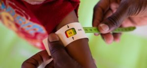 A child's mid-upper arm circumference is measured to see how nourished the child is at a health centre supported by MSF in Fassala, Mauritania, in March 2013. © Nyani Quarmyne