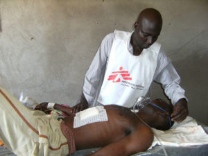 An MSF nurse stabilizes a patient at the hospital in Tissi town.