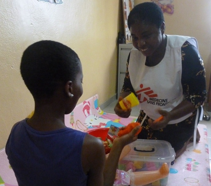 An MSF staff member talks with a young survivor at the MSF sexual violence clinic in Port Harcourt, Nigeria. Photo: Kiera Sargeant and Clare Brennan/MSF