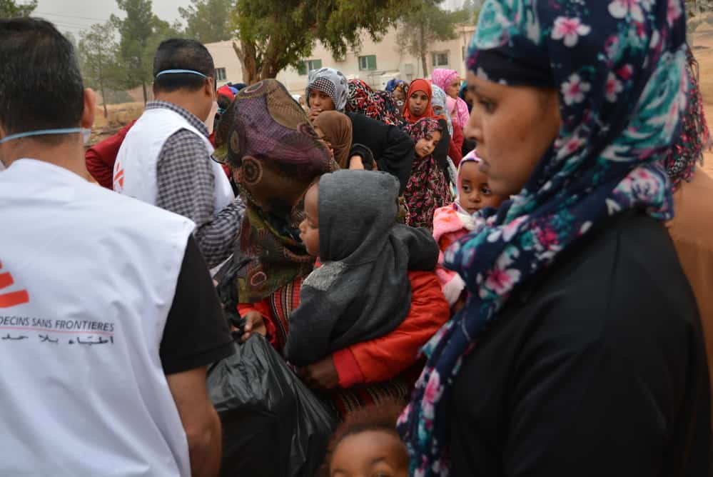 MSF staff distribute powdered infant milk and hygiene items to women and children refugees and migrants in Zintan detention centre. Libya, June 2019. © JÉRÔME TUBIANA/MSF