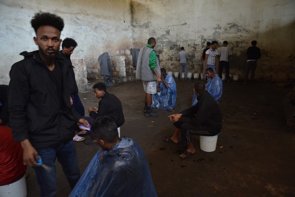 Refugees living among unsanitary conditions in Zintan detention centre. People had access to four barely functioning toilets, buckets to urinate, no shower and only sporadic access to water, which was not suitable for drinking.
© JÉRÔME TUBIANA/MSF