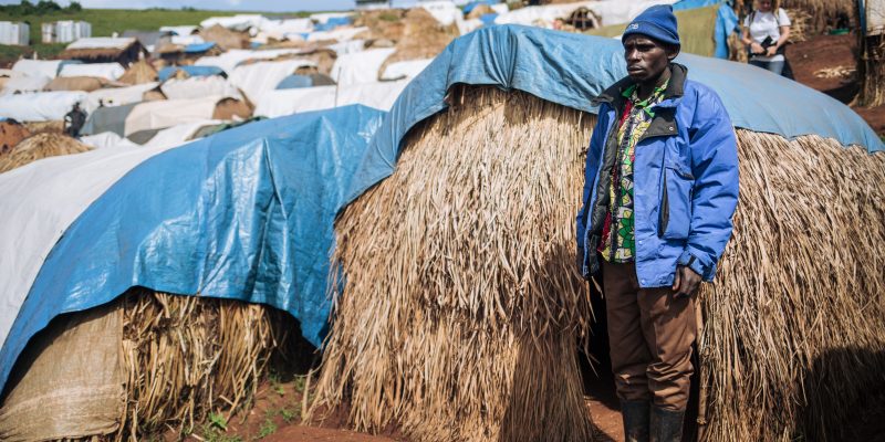 Dieudonné, 32, widower, stands beside his shelter, Rho IDP camp, DRC, November 2019. © ALEXIS HUGUET