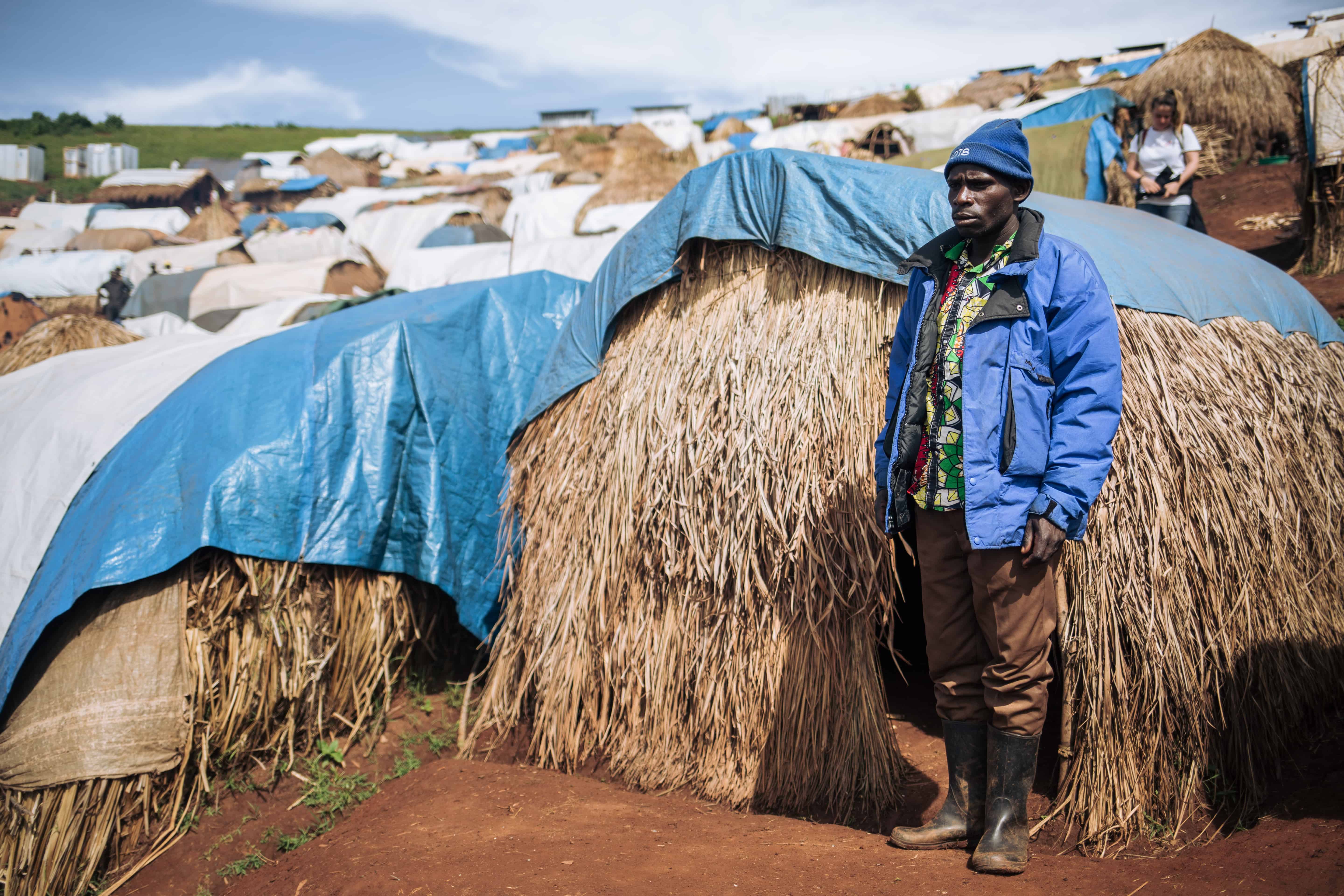 Dieudonné, 32, widower, stands beside his shelter, Rho IDP camp, DRC, November 2019. © ALEXIS HUGUET
