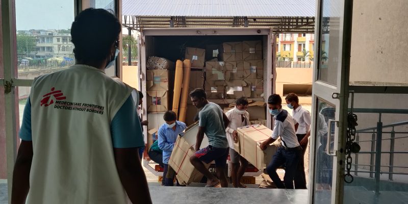 The Logistics team unloading the required material, including beds and PPEs for the MSF's 100-bed COVID treatment facility at Patliputra sports complex, Patna. ©MSF