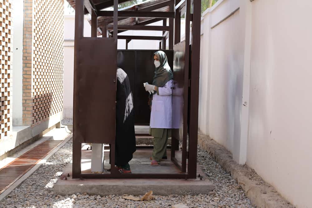 MSF nurse Aziza Khushal waits to collect a sputum sample from a new patient on the women’s side of the Médecins Sans Frontières (MSF) drug-resistant tuberculosis (DR-TB) hospital in Kandahar city, Kandahar Province, Afghanistan.
