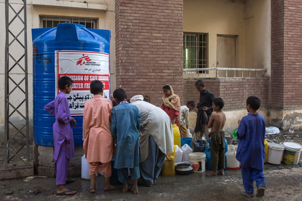 People collect drinking water from the MSF installed water tank inside labor colony flood camp in Sukkur Sindh province of Pakistan on 28th October 2022.