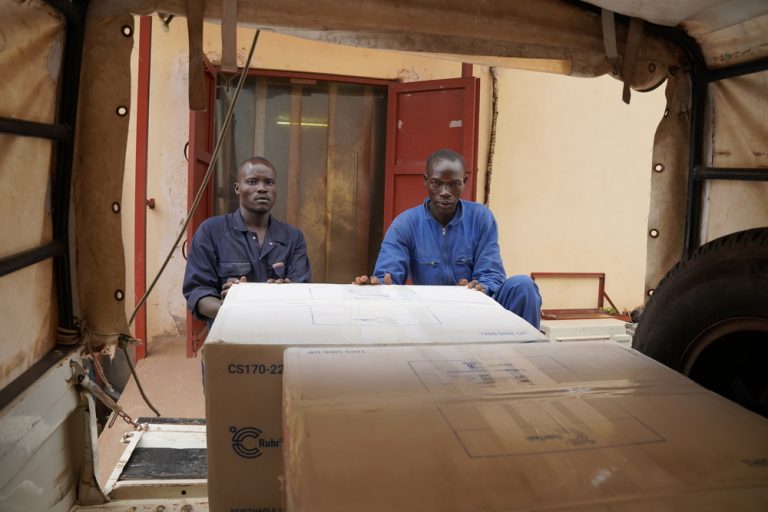 Members of the MSF team load a box containing hepatitis E vaccines into an MSF vehicle. The vaccines are being sent to Fangak County, Jonglei State.