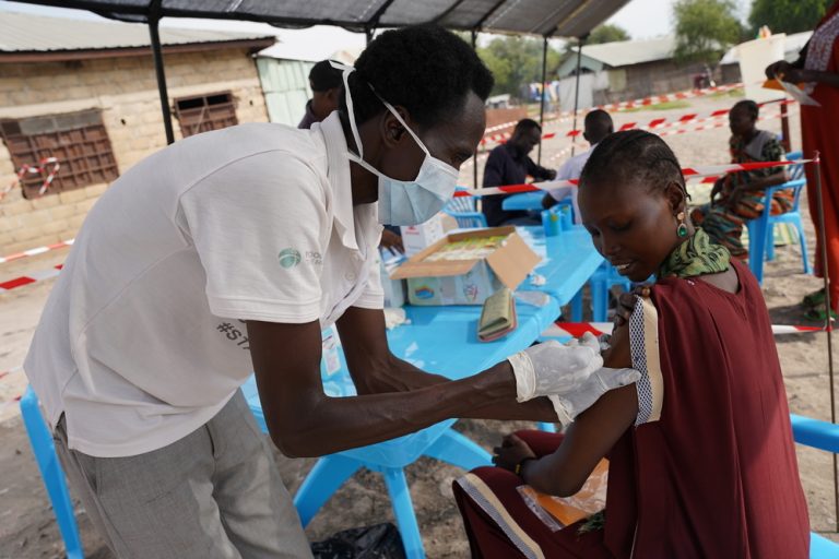 An MSF staff administers the hepatitis E vaccine to a woman in Hai Matar, Jonglei State.