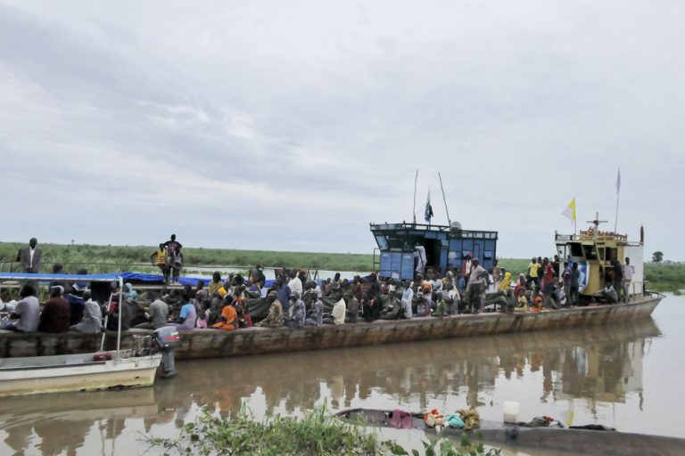 A boat used to transfer hundreds of men, women and children docks at Bulukat port in Malakal, Upper Nile State in South Sudan. The Bulukat transit centre hosts thousands of returnees transferred from Renk after they fled the conflict in Sudan.