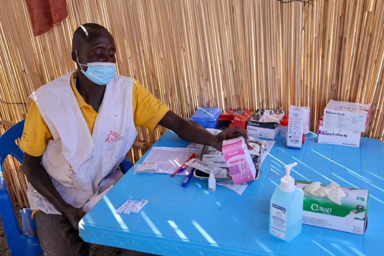 Laboratory Assistant Kong Ngor conducts malaria tests inside the MSF mobile clinic at the Zero Transit Centre in Renk, Upper Nile state.