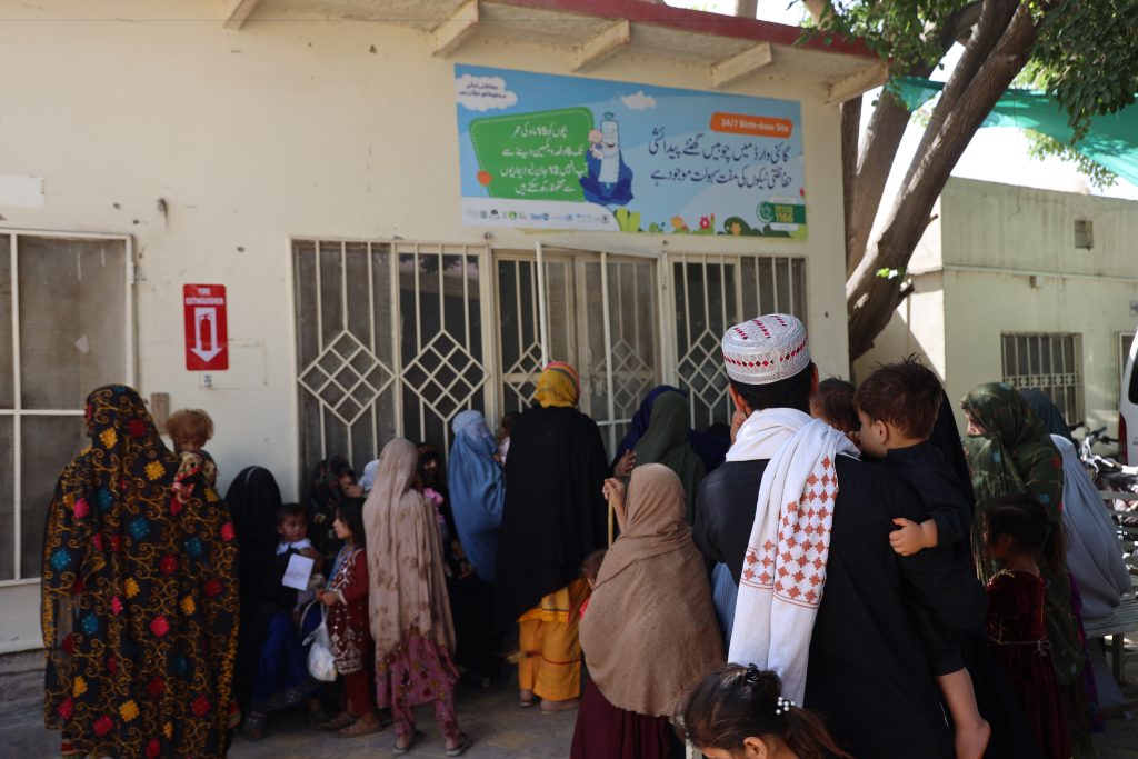 Several parents are waiting outside the registration room to register their children for consultation at the MSF Mother and Child Healthcare facility in Kuchlak.