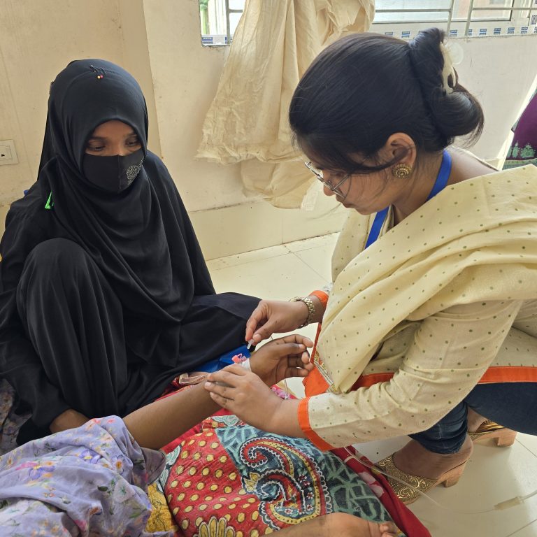 An MSF nurse giving medication and preparing a patient suffering from acute watery diarrhea for a saline injection. The adult diarrhea ward in Noakhali General Hospital following the floods in Noakhali.