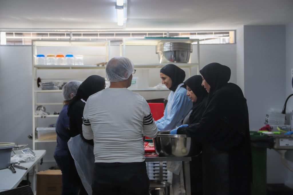 Cooked food distribution in Azarieh shelter