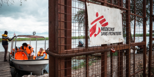 MSF’s hospital in Old Fangak backs on to a mooring quay on Zeraf River, useful for launching mobile vaccination clinicsand transferring patients via the ever-increasing floodways. © Florence Miettaux5 MSB184469A woman walks in front of the entrance of the MSF hospital in Old Fangak, Jonglei State. © Gale Julius Dada/MSF